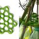 Illustration for article titled This 3D-Printed Web of Plastic Caps Turns Water Bottles Into a Vase